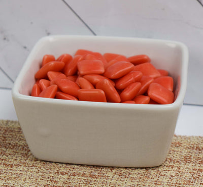 Pink bubblegum tabs in white ceramic bowl