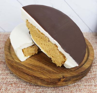 Peanut Butter Cup Coated in White and Dark Chocolate, Cut in Half to Reveal Peanut Butter Filling
