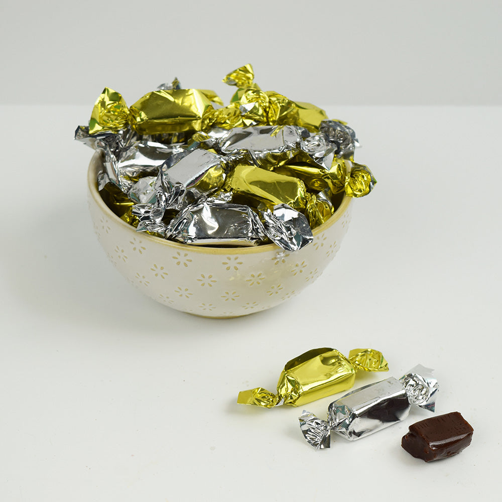 Bowl filled with gold and silver wrapped coffee prims