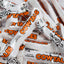 Pile of Cow Tales candy bars with orange and black text and cartoon cows.