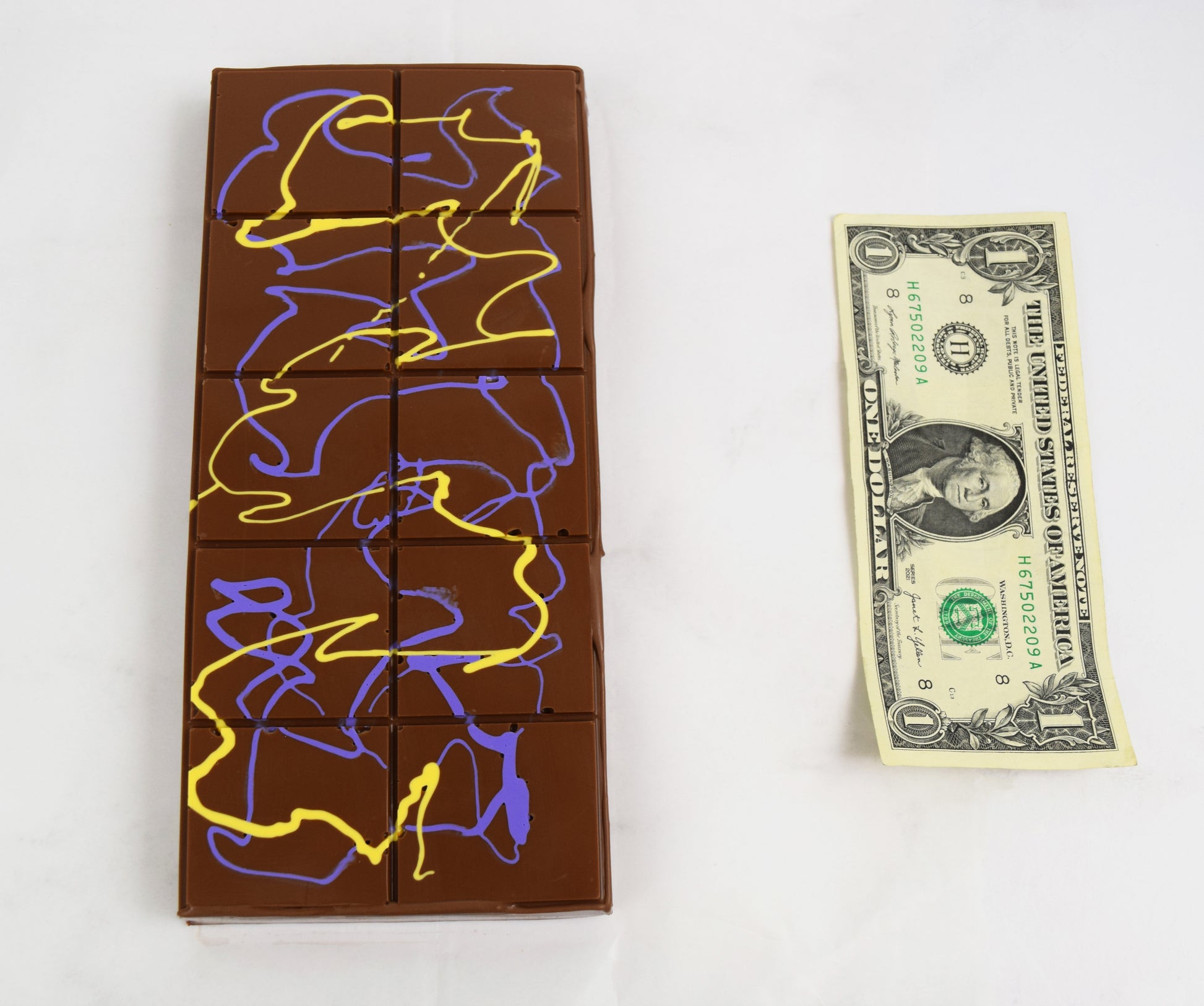 Dubai Chocolate bar next to a one-dollar bill 