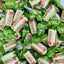 Pile of Rossana Pistacchio candies in green and white wrappers.