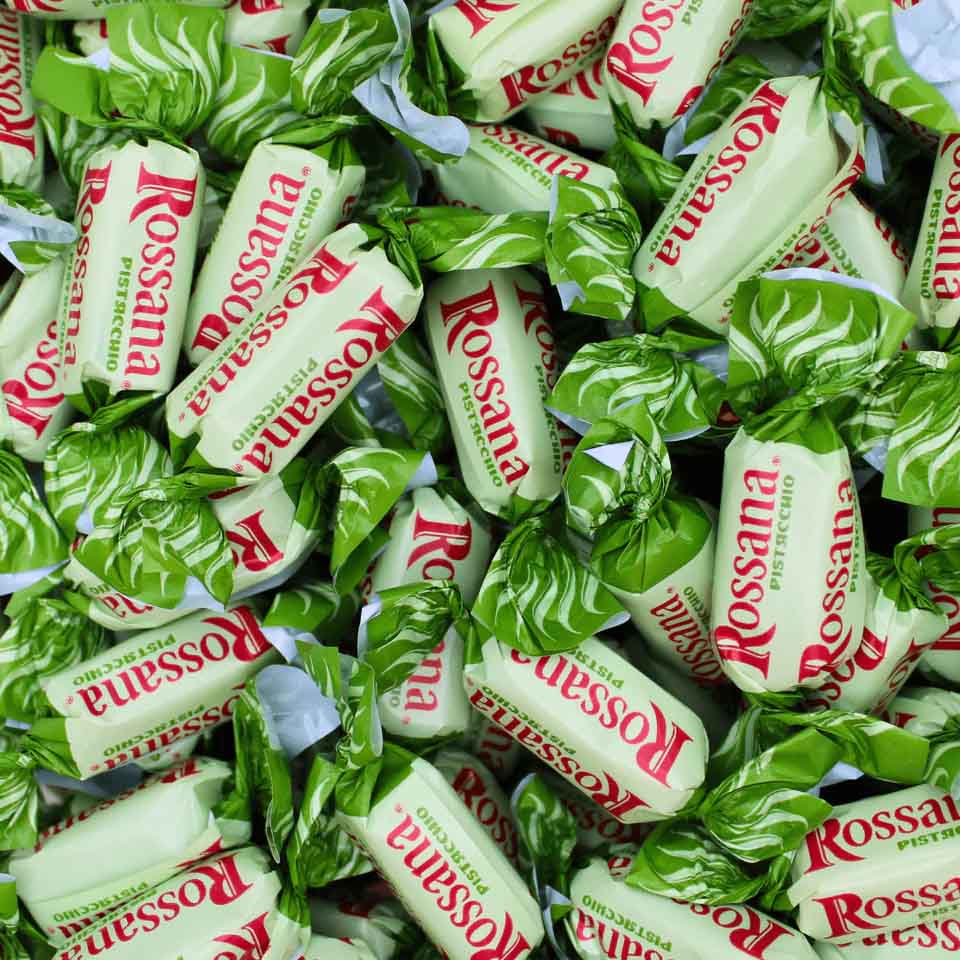 Pile of Rossana Pistacchio candies in green and white wrappers.